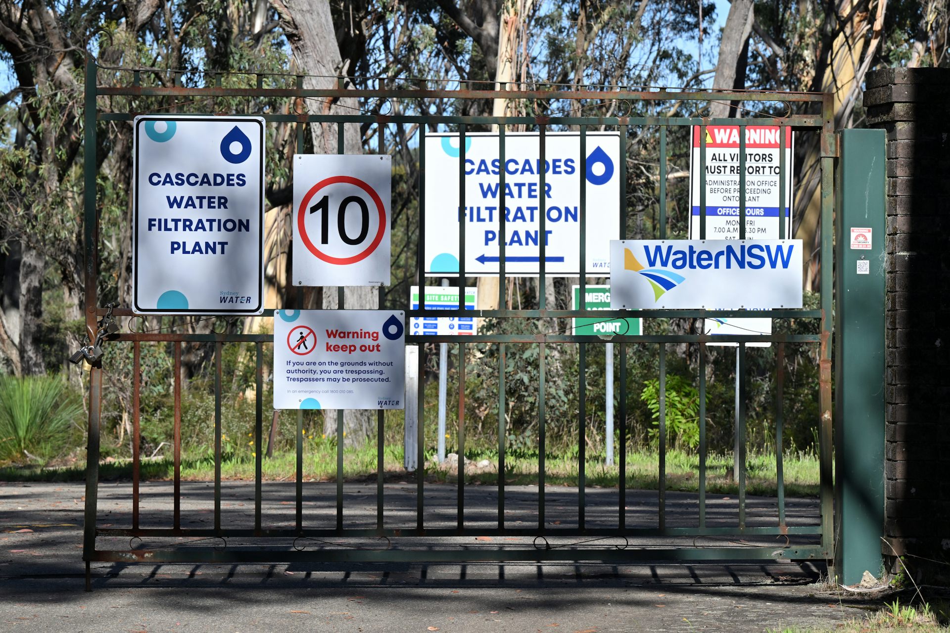 A gate of the water treatment plant with signs on it.