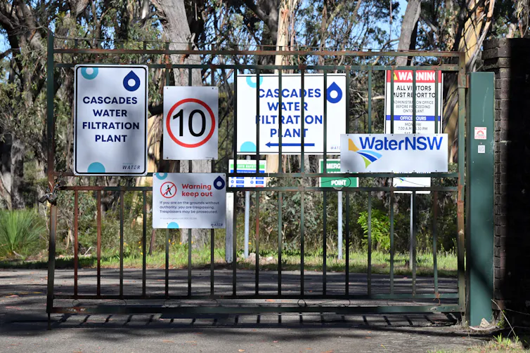The gate of the water treatment plant with a sign posted.