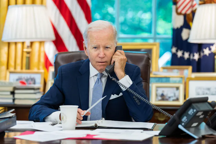 Joe Biden on the telephone in the Oval Office