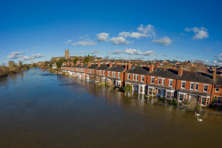 A terraced street surrounded by flood water.
