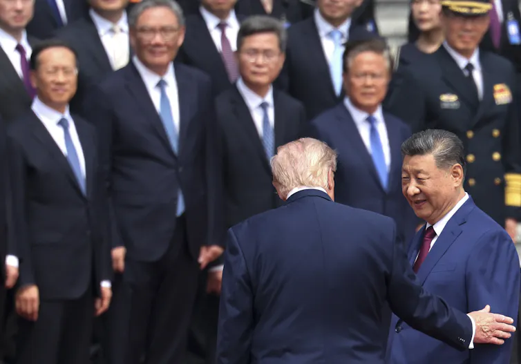 Xi Jinping greets Donald Trump at a welcome ceremony in Beijing.
