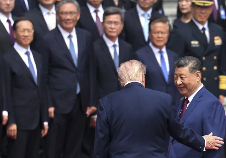 Xi Jinping greets Donald Trump at a welcome ceremony in Beijing.