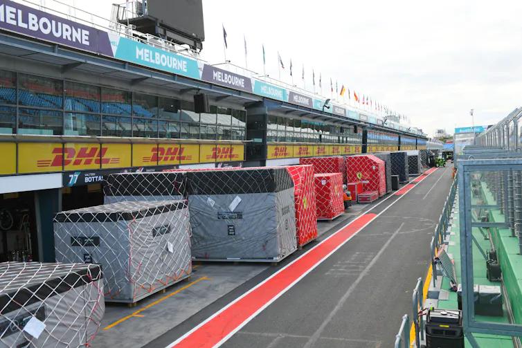 Method 1 racing presentations the onerous a part of attaining net-zero carbon emissions isn’t the engineering 1 Equipment containers sit alongside a road beneath viewing stands.