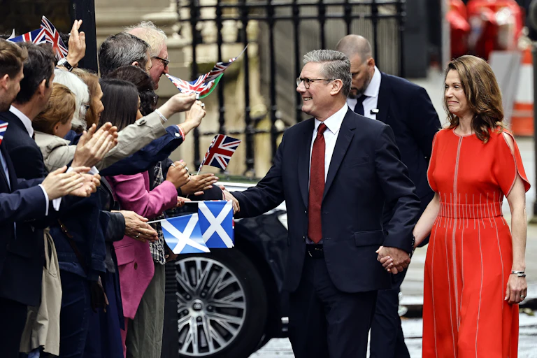 keir starmer and wife victoria meet wellwishers waving flags as he arrives at downing street after winning the general election.