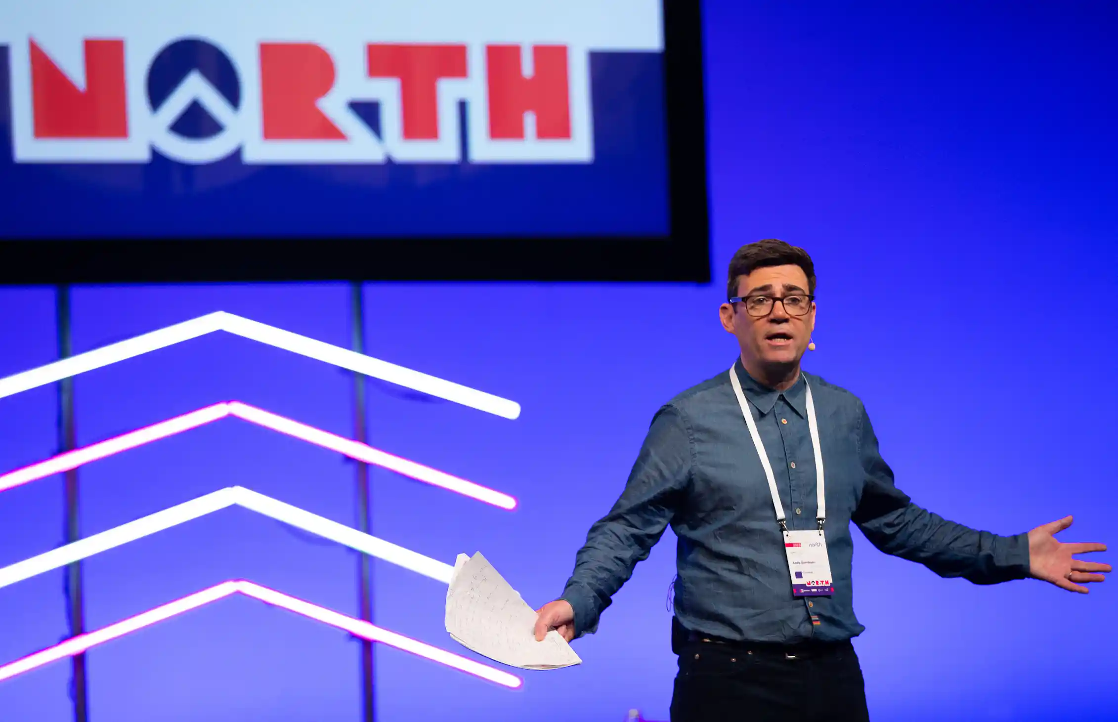 andy burnham against a blue backdrop reading 'north'