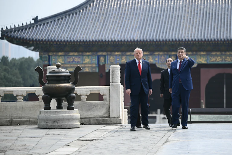 Two men walk outside a temple