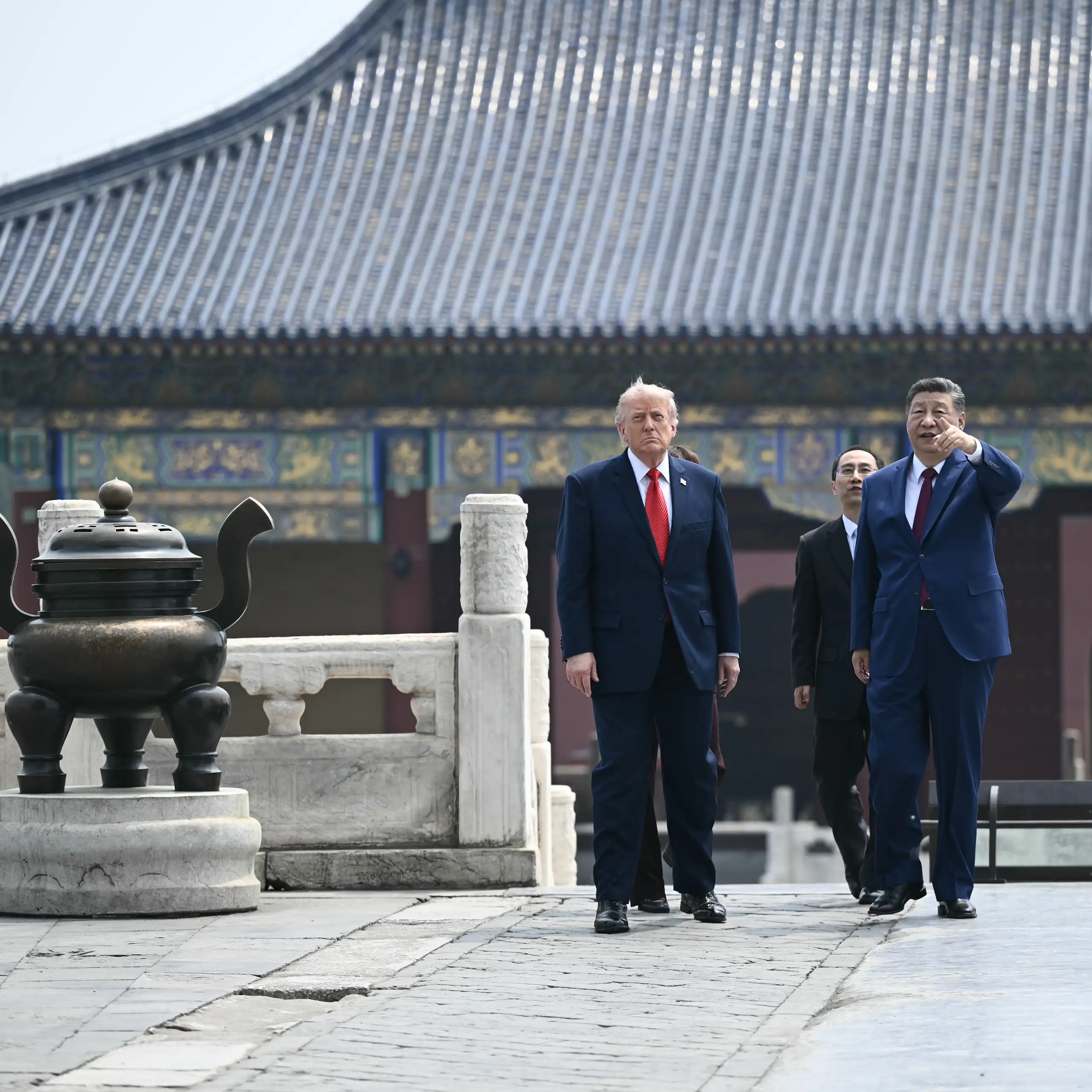 Two men walk outside a temple