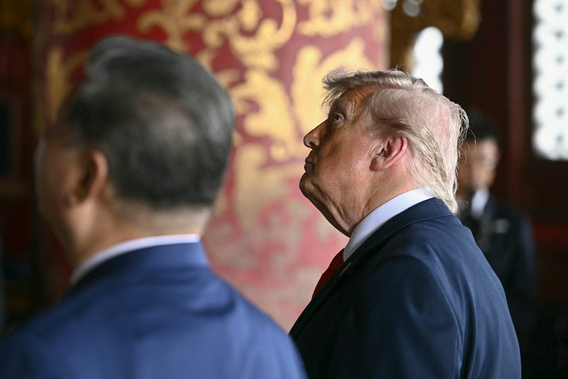 Two men in suits look away from the cabinet.