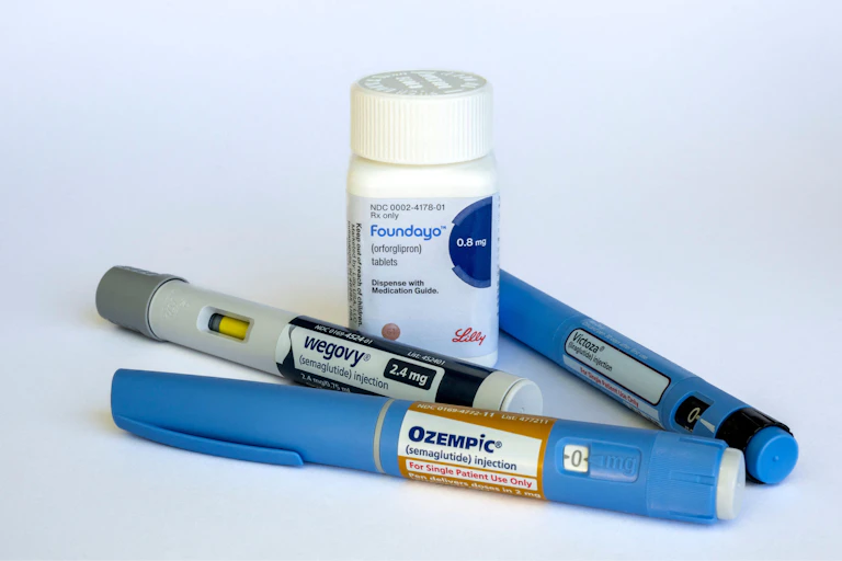 Foundayo weight-loss oral pill surrounded by weight-loss jabs.