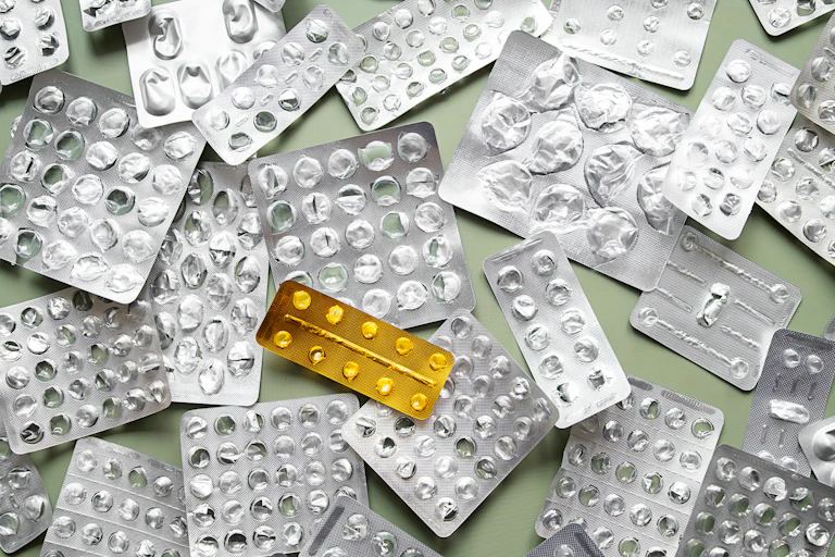 An assortment of empty blister packs of medicines.