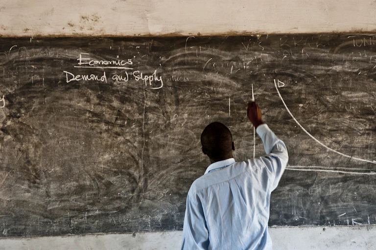 Man writing on blackboard