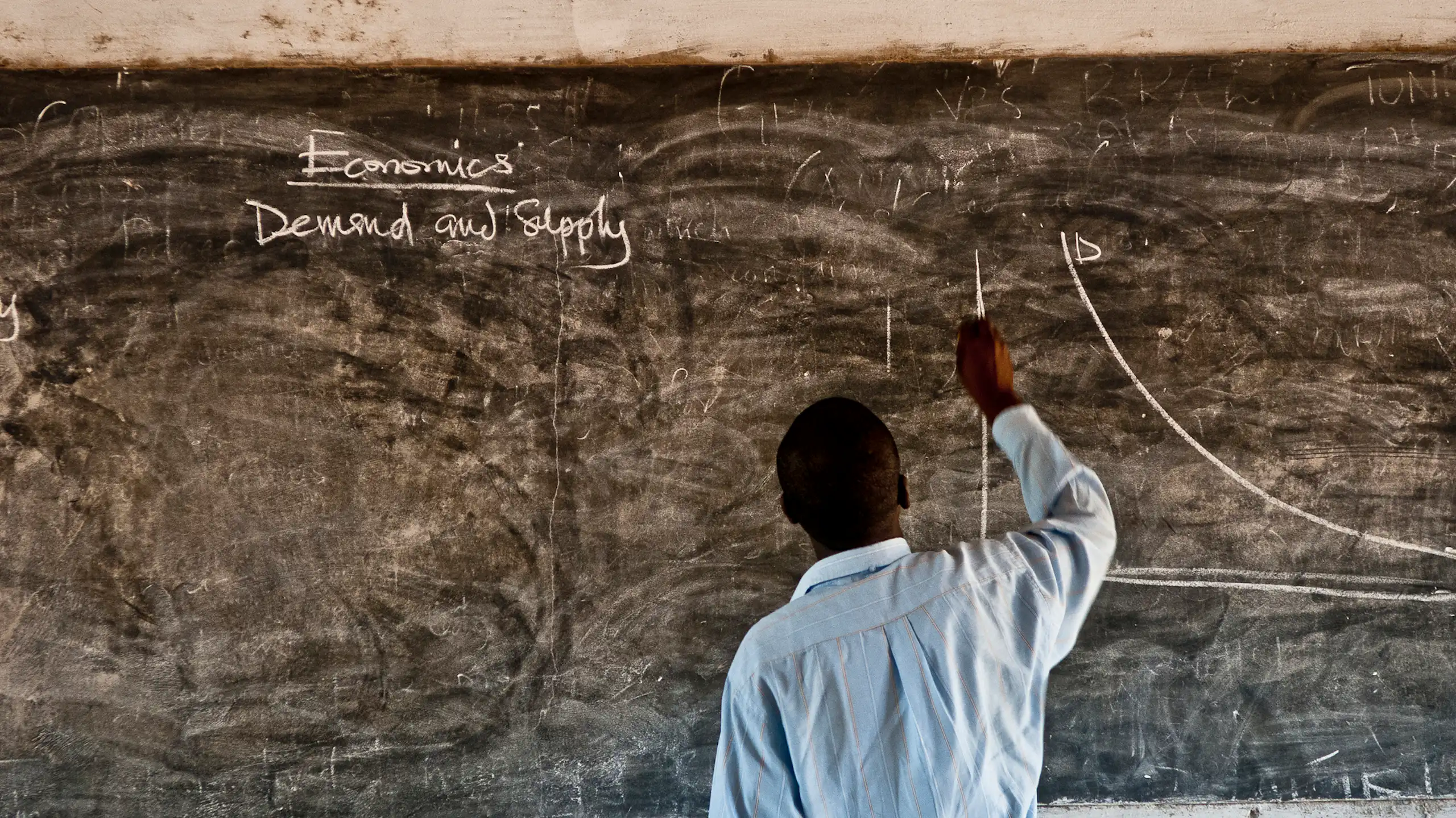 Man writing on blackboard