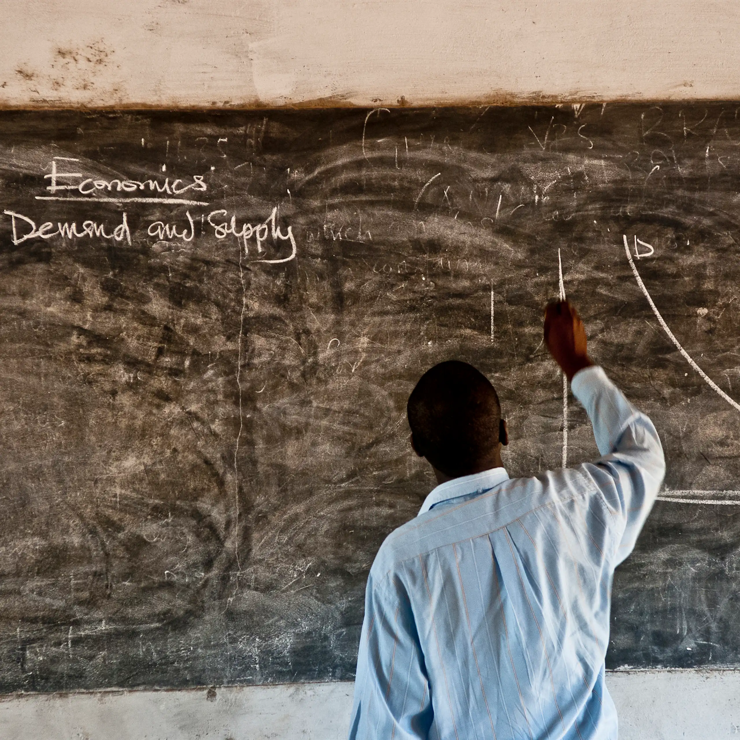 Man writing on blackboard