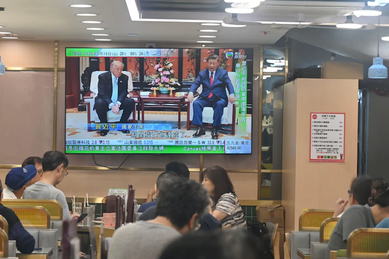A large TV screen shows the summit meetings between US president, Donald Trump, and Chinese president, Xi Jinping.