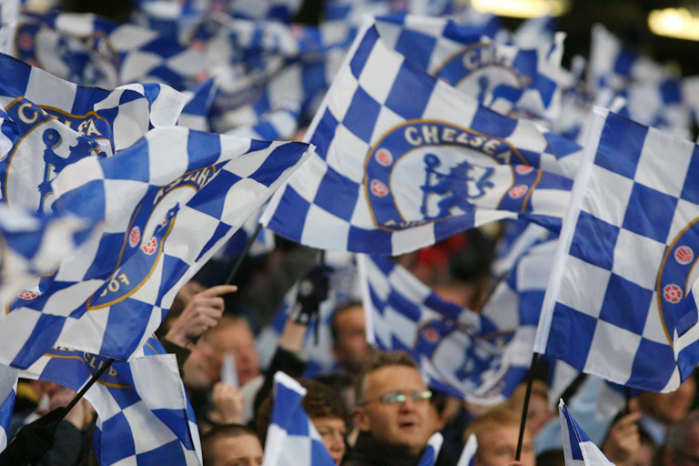 Fans waving Chelsea flags.