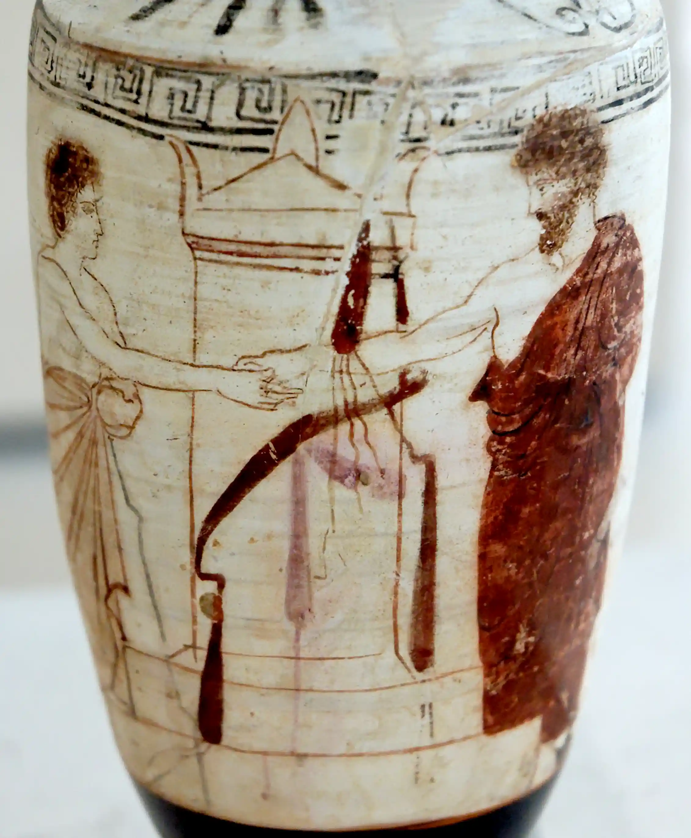 An ancient Greek jug depicts two people shaking hands.