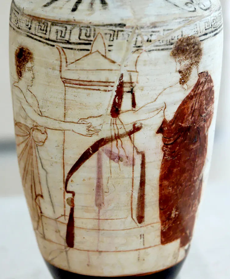 An ancient Greek jug depicts two people shaking hands.
