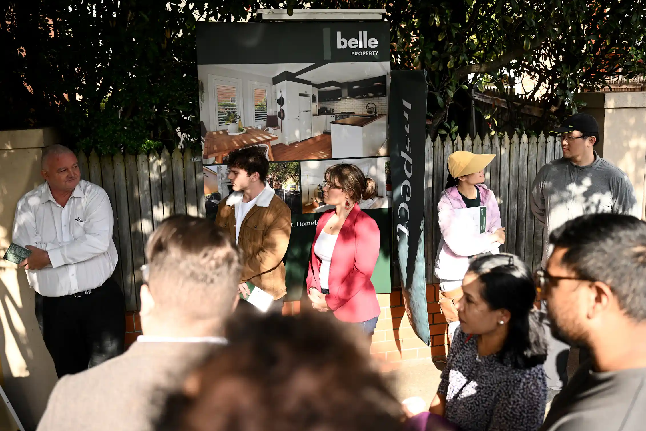Potential home buyers attend a property auction in Sydney