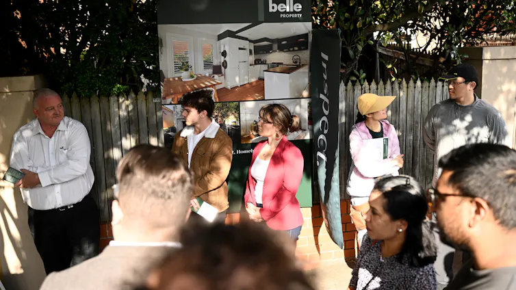 Potential home buyers attend a property auction in Sydney