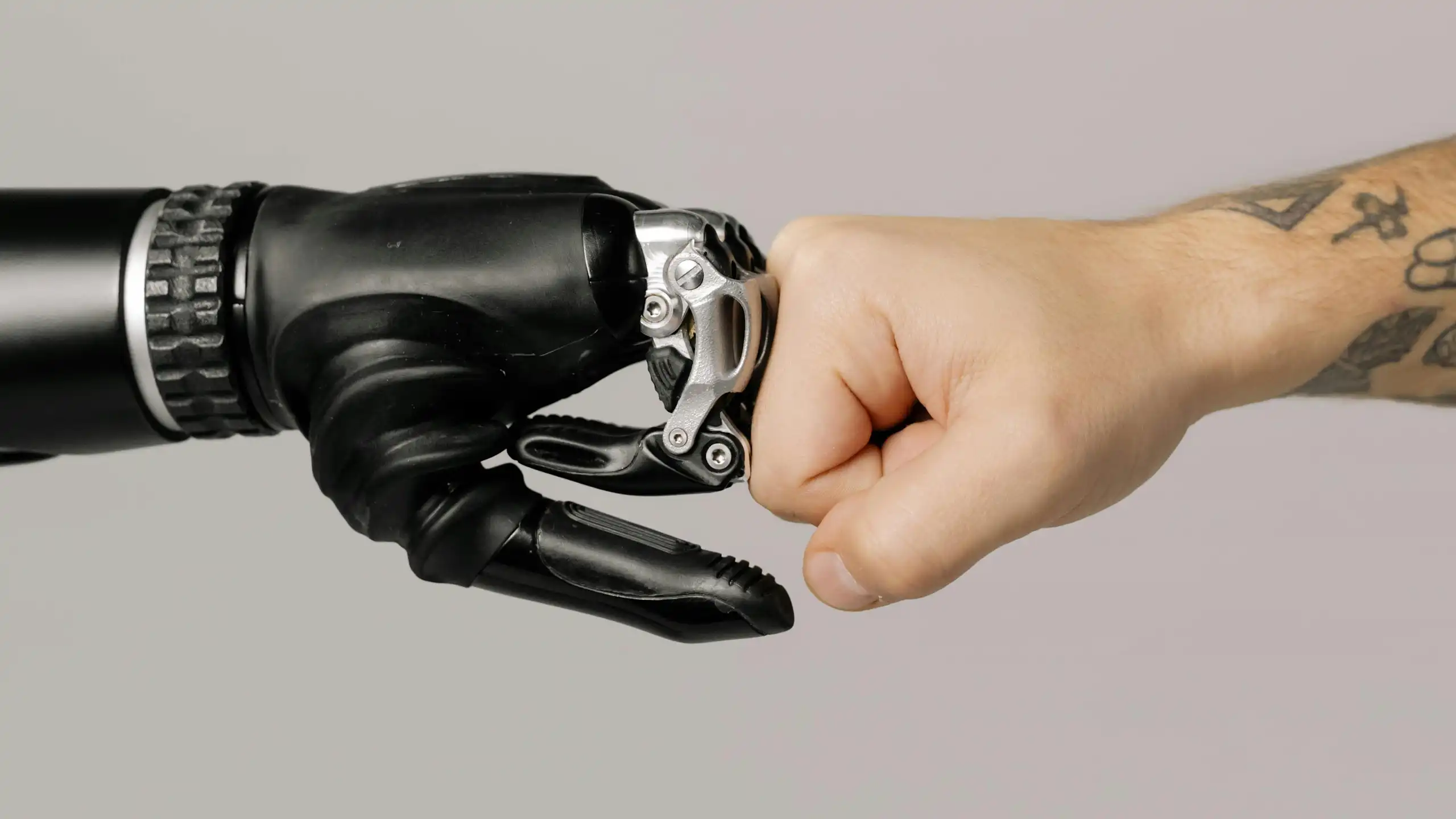 An illustration of a robot fist up against a human fist.