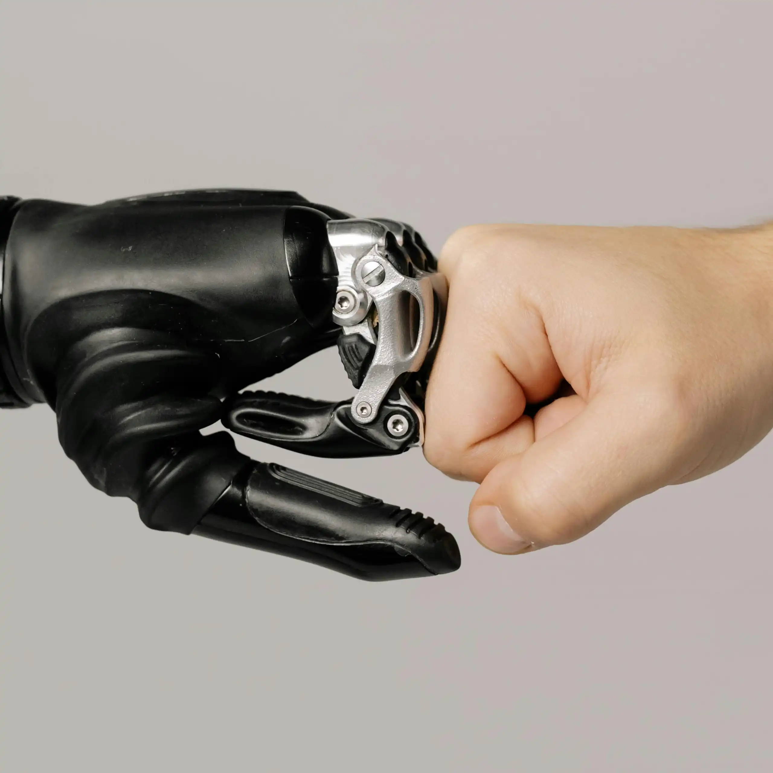 An illustration of a robot fist up against a human fist.