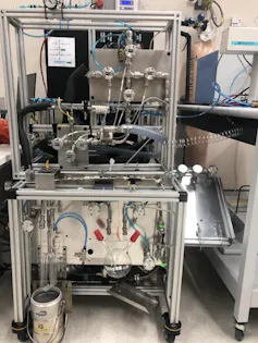 A silver machine with many different pipes and containers