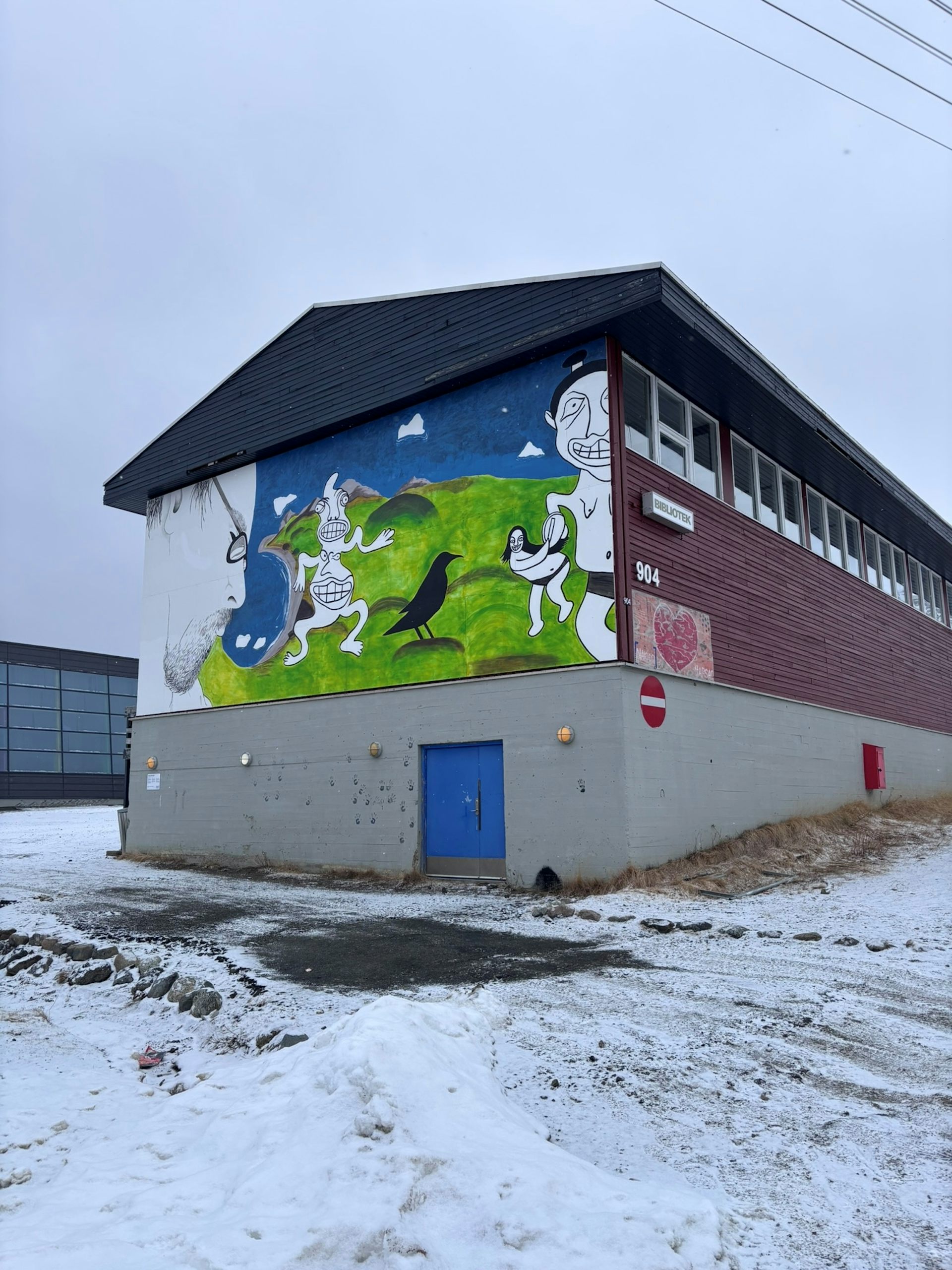 A mural painted on the  wall of a library building by Egede Godtfredsen in Narsaq, South Greenland.
