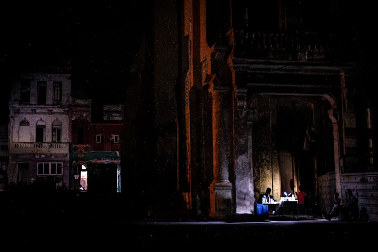 2 small lights show on a darkened Havana street
