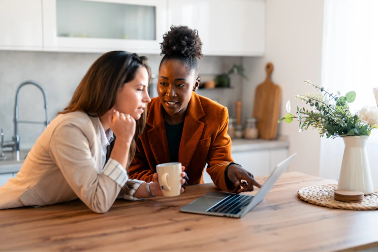 Two women looking at a laptop