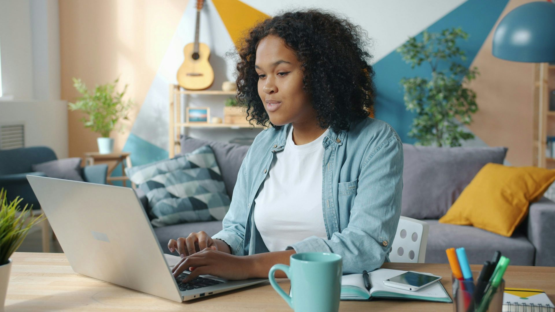 Une jeune femme assise devant son ordinateur