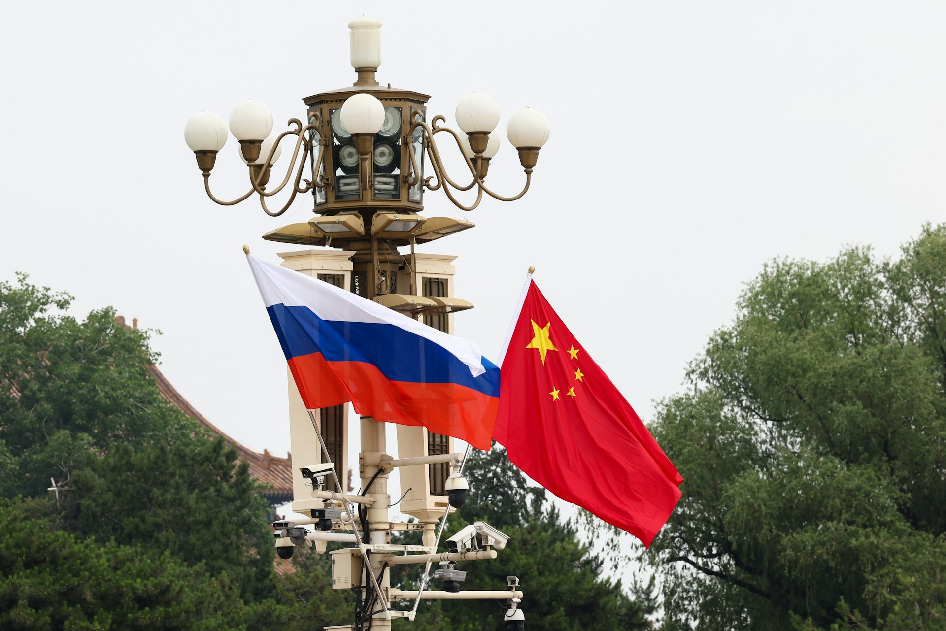 The Russian and Chinese flags flutter at Tiananmen Square in Beijing.