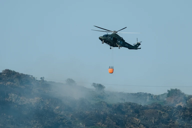 A helicopter above wildfire countryside in Howth, near Dublin.