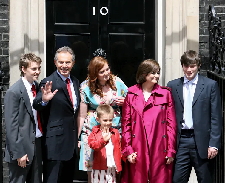 tony blair, his wife and four children on the steps of downing street as they leave for the last time.