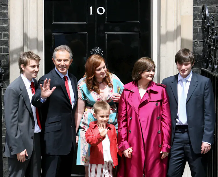 tony blair, his wife and four children on the steps of downing street as they leave for the last time.