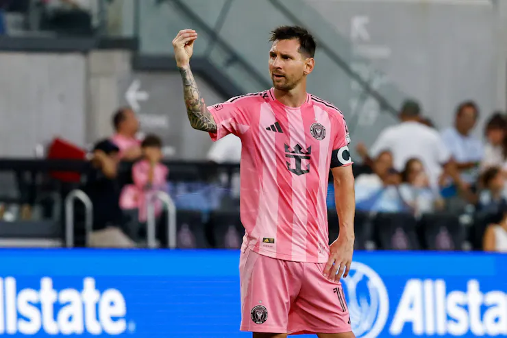 Lionel Messi in an Inter Miami uniform makes the 'money' hand gesture.