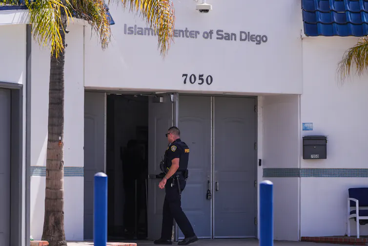 A police officer enters a building.