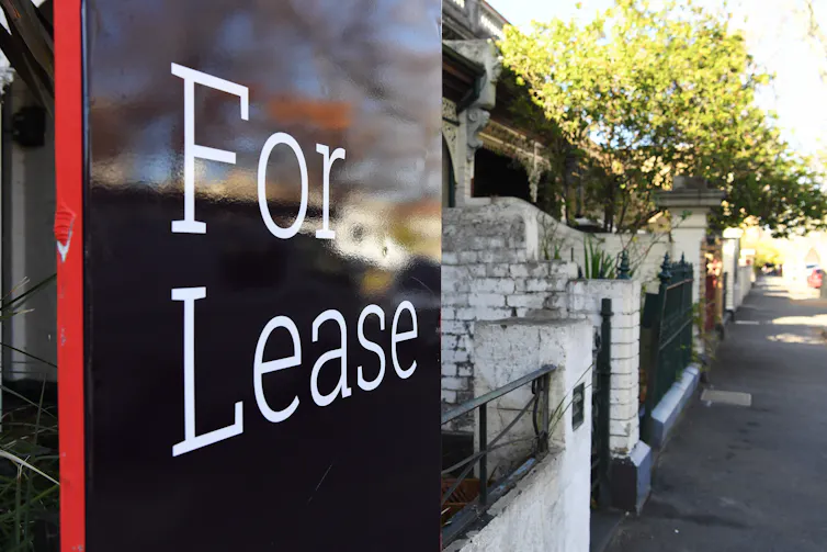 Signage that reads for lease on a residential street.