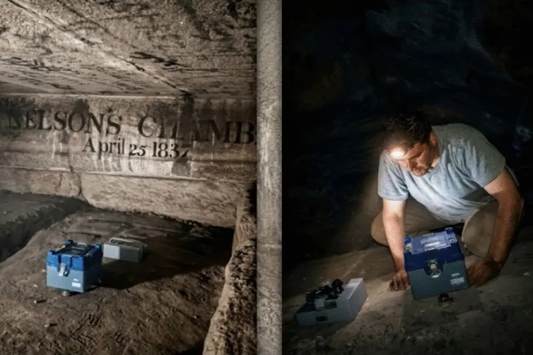 Man crouching in stone chamber with instruments