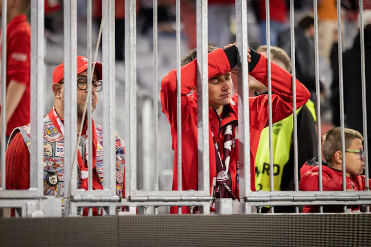 Disappointed Bayern Munich fans after their team was knocked out of the Champions League by Paris Saint-Germain.