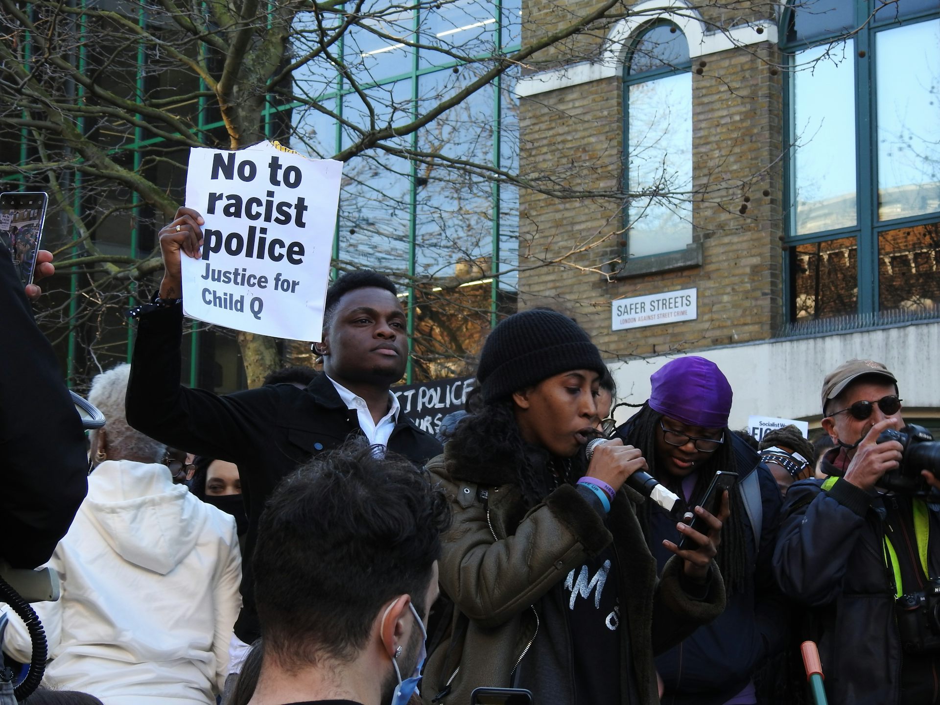 Marchers with a sign that says 'no to racist police, justice for Child Q'