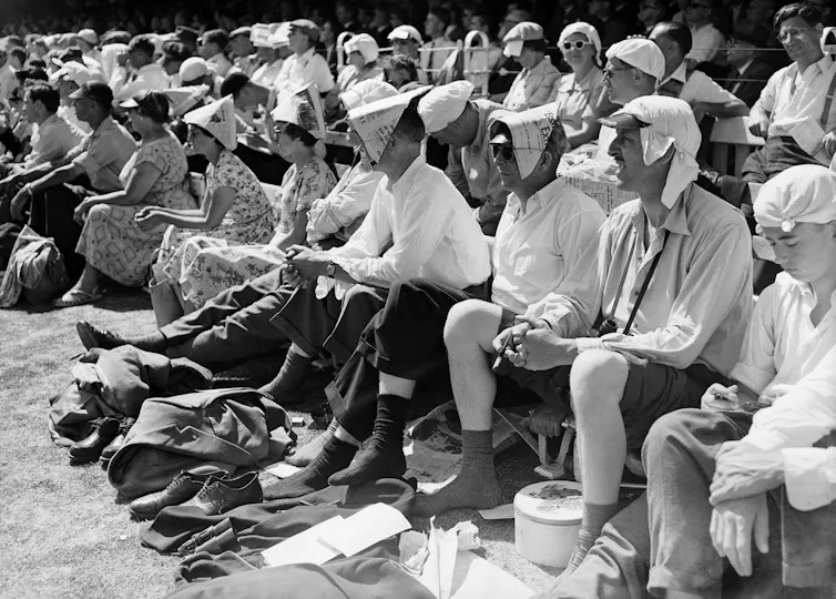Cricket fans struggle in the heat at Lord's in London.