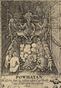 A black and white illustration shows a man in a feather headdress sitting on a platform above a seated crowd.