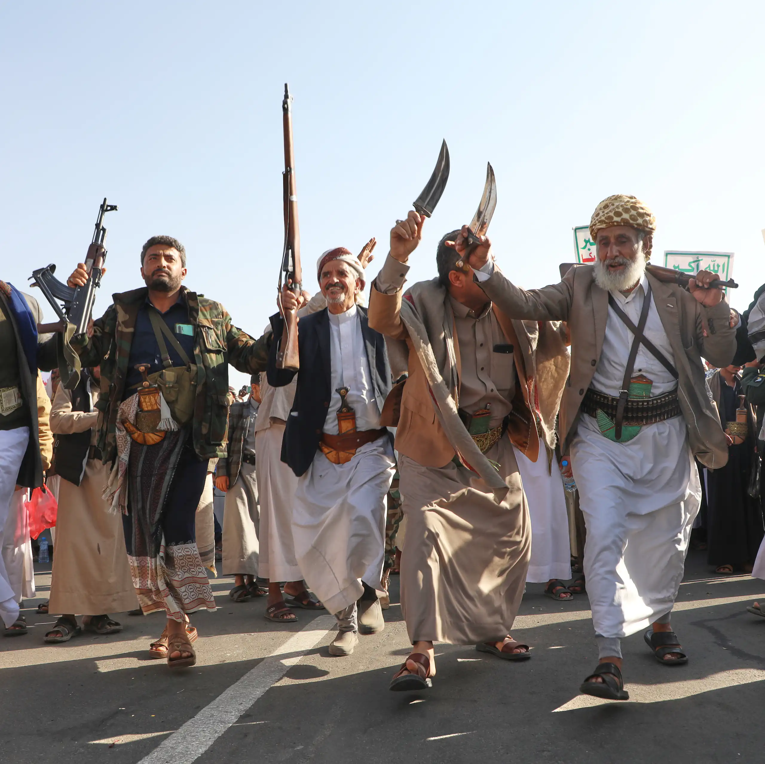Houthi supporters dance to celebrate