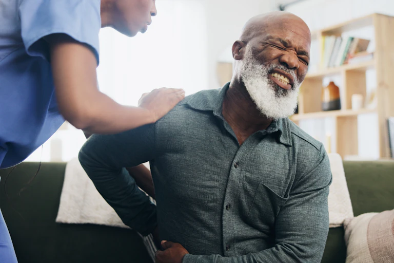 An elderly black man in pain.