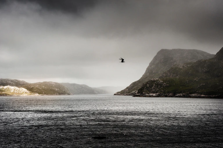 A brooding image of the Hebridean island of Harris with storm clouds gathering and the light changing on the grey sea.