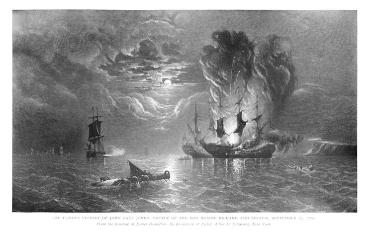 A black-and-white image shows two ships at battle