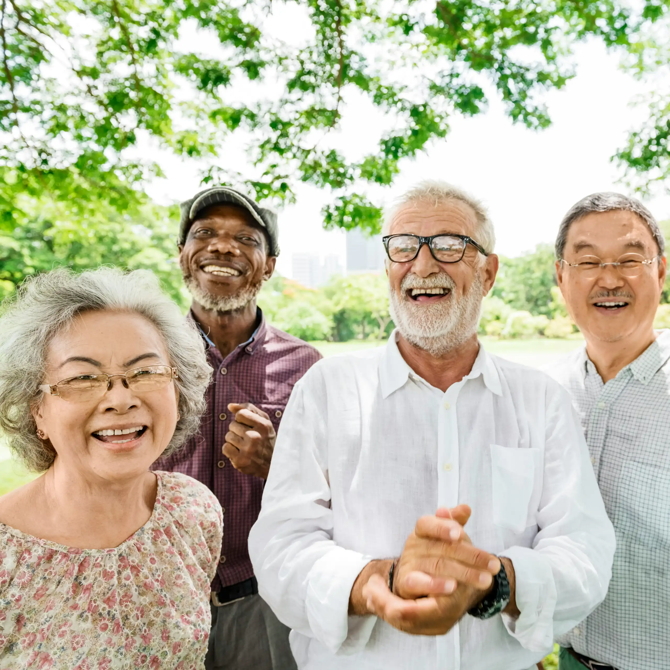 Five older adults smiling in an outdoor setting