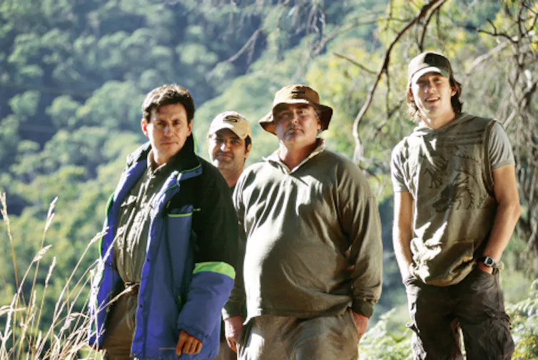 four men standing in Australian wilderness