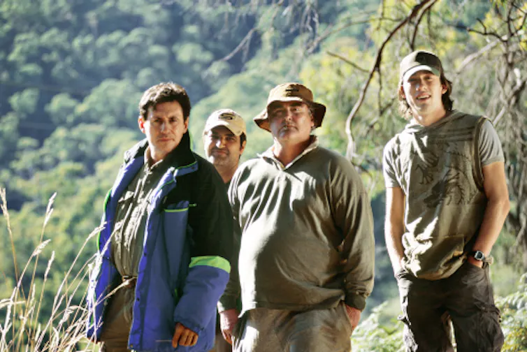 four men standing in Australian wilderness