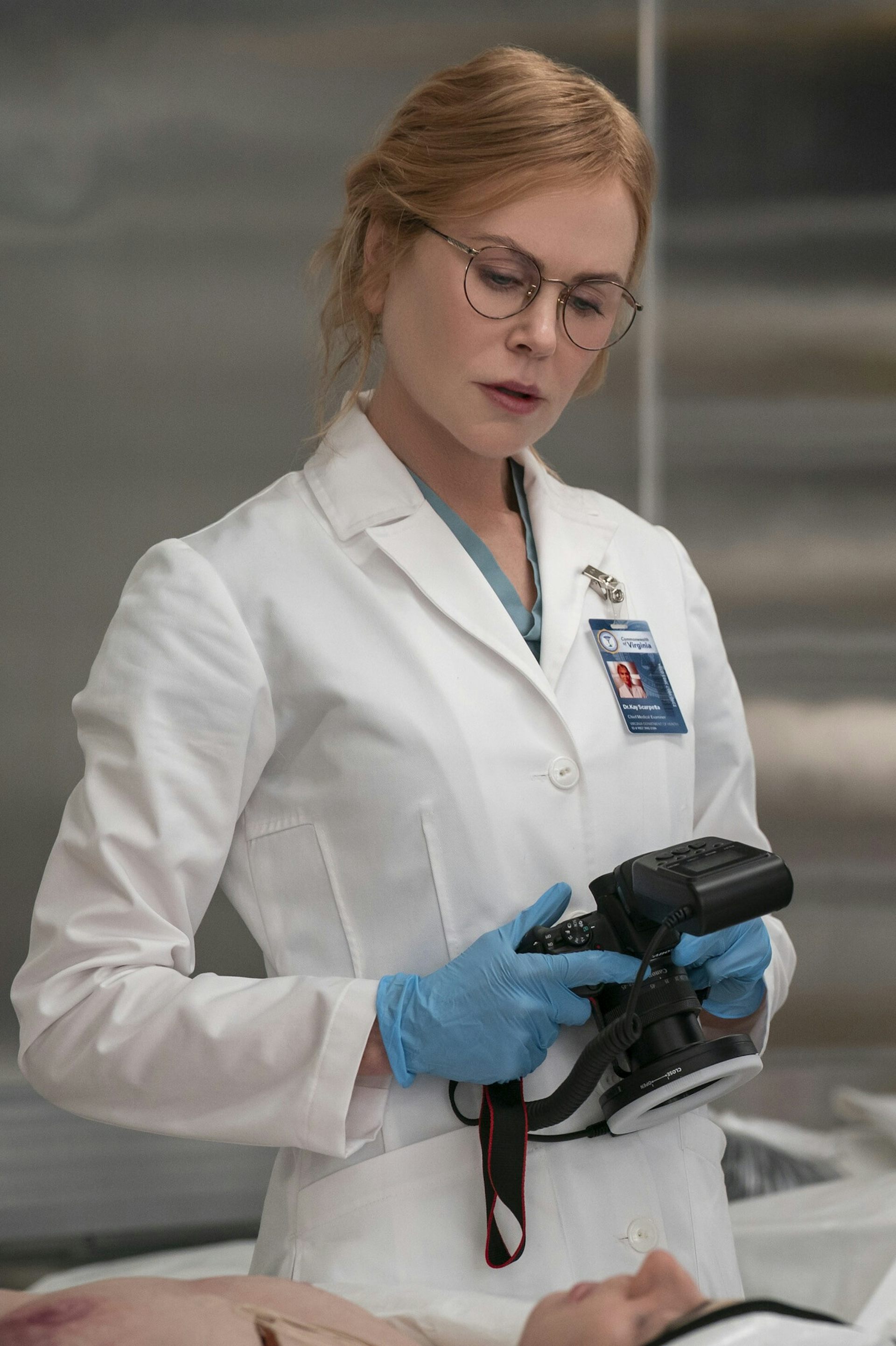 a woman in a white coat in a morgue